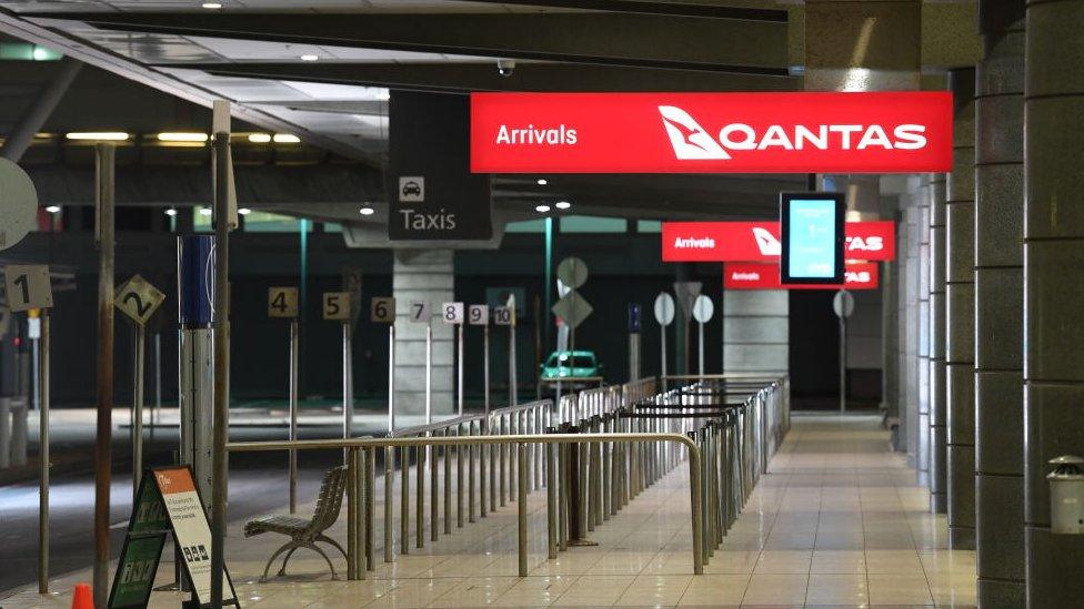 An empty airport below a sign saying "Qantas arrivals"