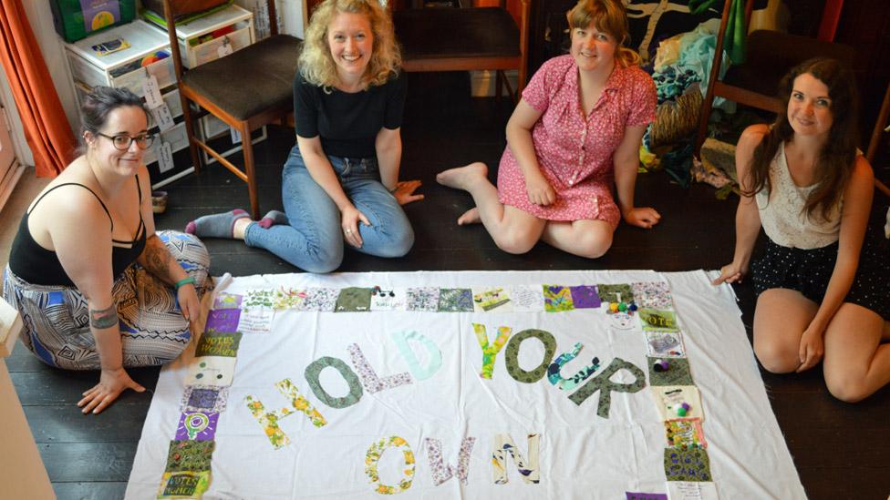 Girl Gang Manchester with their "Hold Your Own" banner