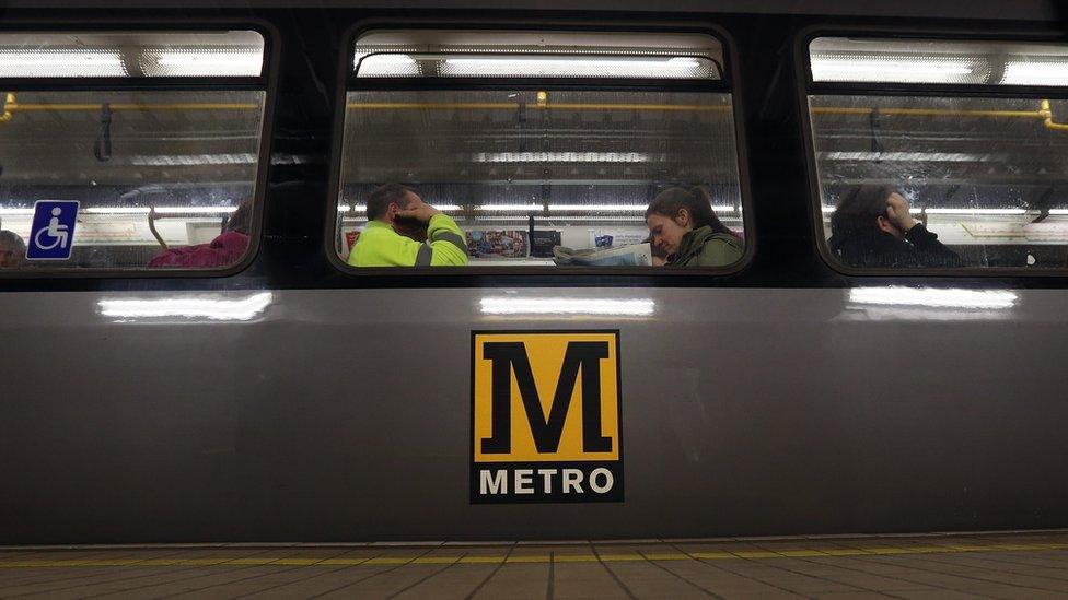 Close up of people sat on a Metro train