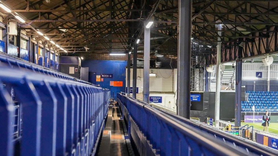 Blue seating and rails at a football stadium