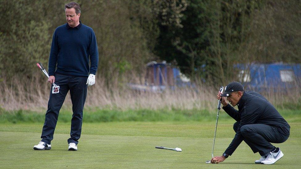 US President Barack Obama (R) lines up a putt as British Prime Minister David Cameron (L) looks on at at The Grove Golf Course near Watford in Hertfordshire.