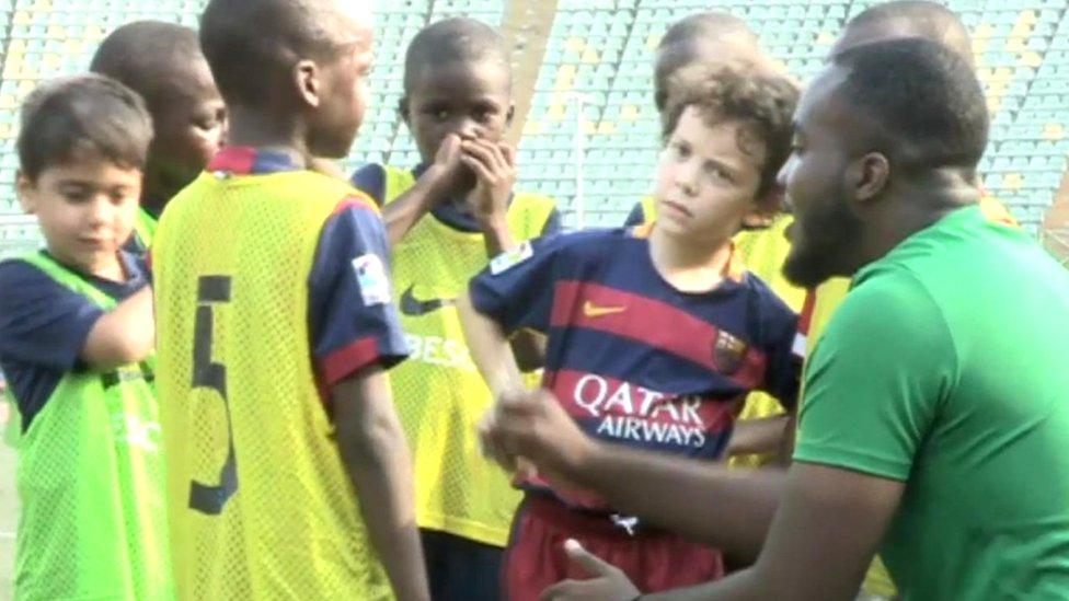 Children and a coach at FCBescola Lagos