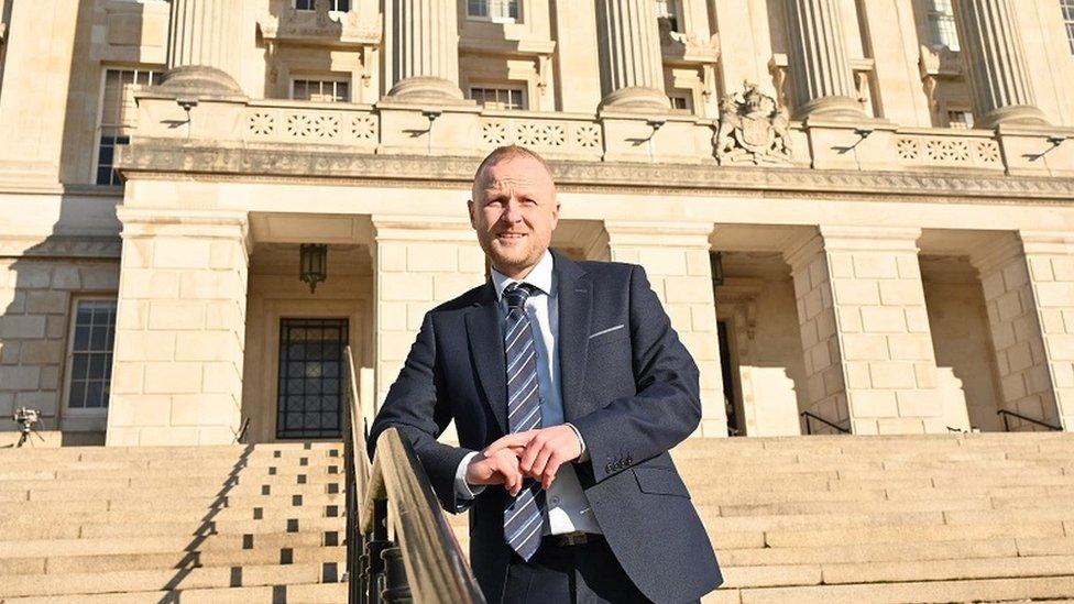 Jamie Bryson on steps of Stormont