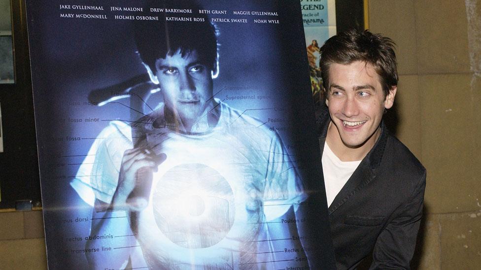 Jake Gyllenhaal with a Donnie Darko film poster