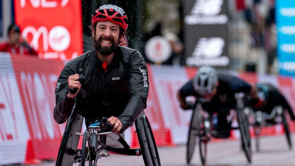 Man in wheelchair, finishing the marathon