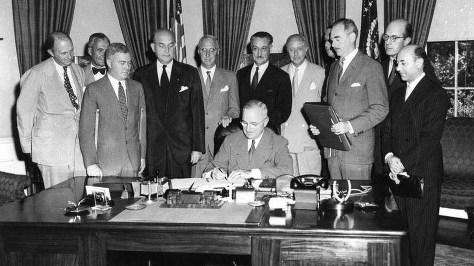 President Harry Truman signing a treaty