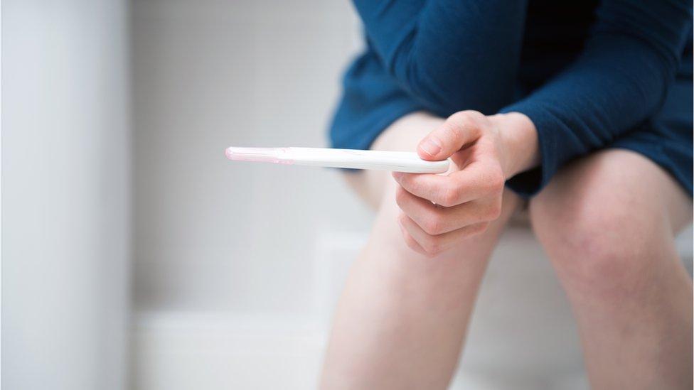 Woman taking pregnancy test