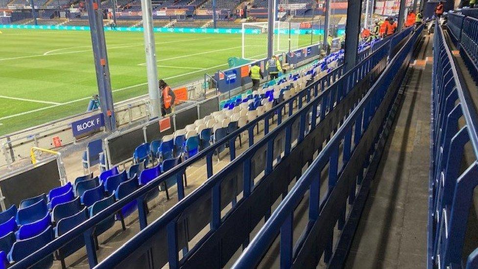 Blue seats and rails at a football stadium