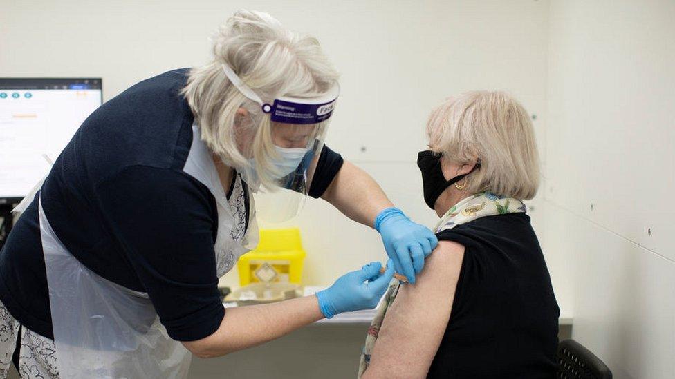 woman receiving covid vaccine