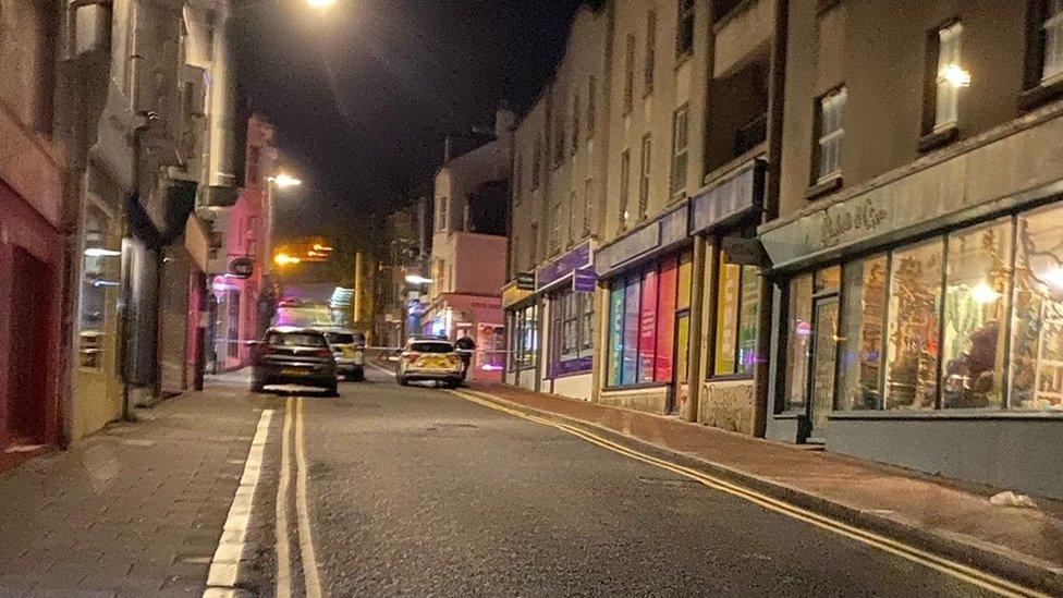 The street during the night with police cars and a cordon