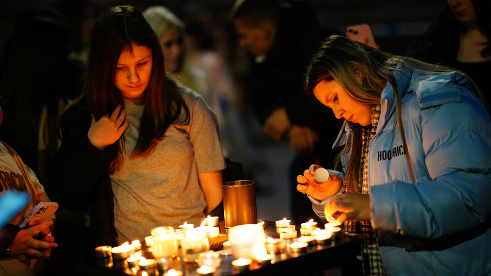 People take part in a vigil near to the scene in south Bristol where two teenage boys,