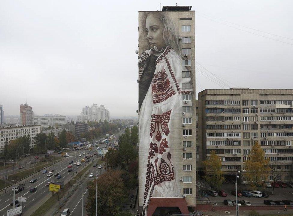 Guido van Helten's mural on the side of an 18-storey apartment block in Kiev, Ukraine