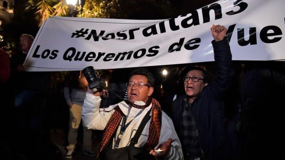 Relatives and colleagues of two journalists and a driver who were abducted on the border with Colombia, demonstrate during a vigil at the Independence square in Quito on March 27, 2018.