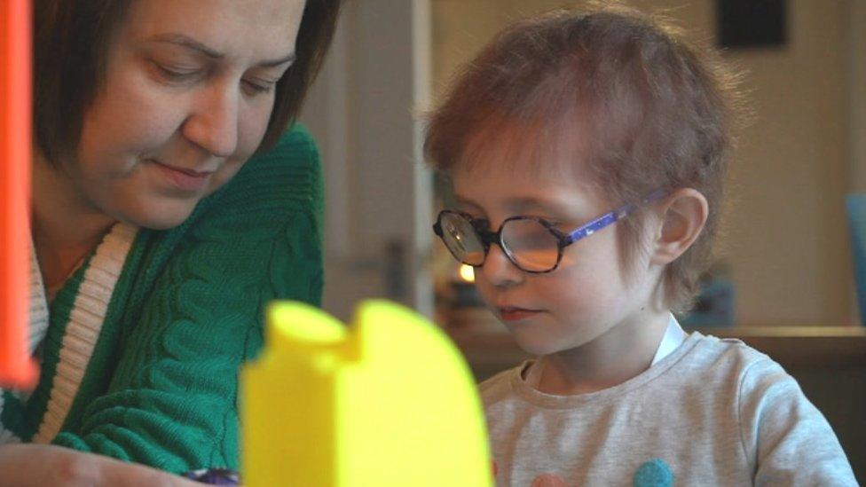 Debra and Dulcie play with a dolls house