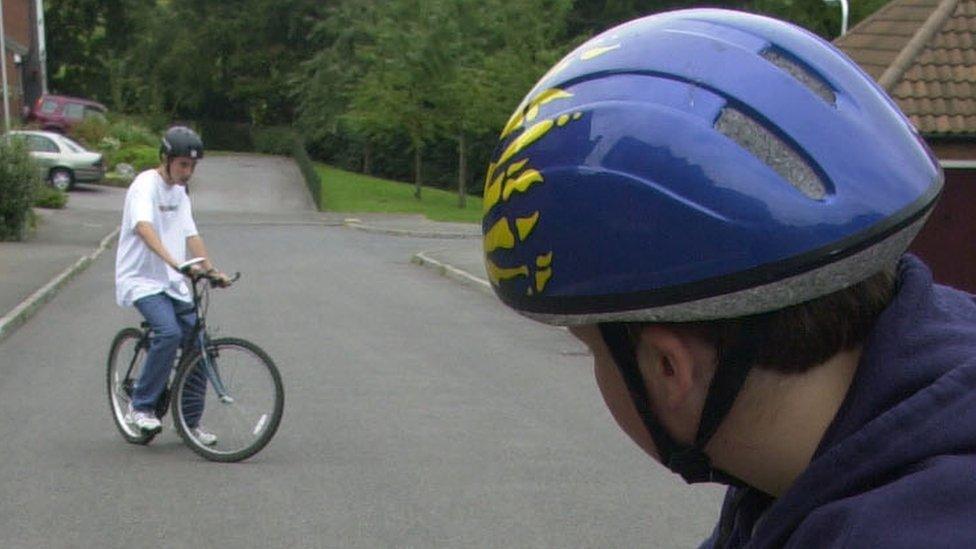 Boys wearing cycle helmets