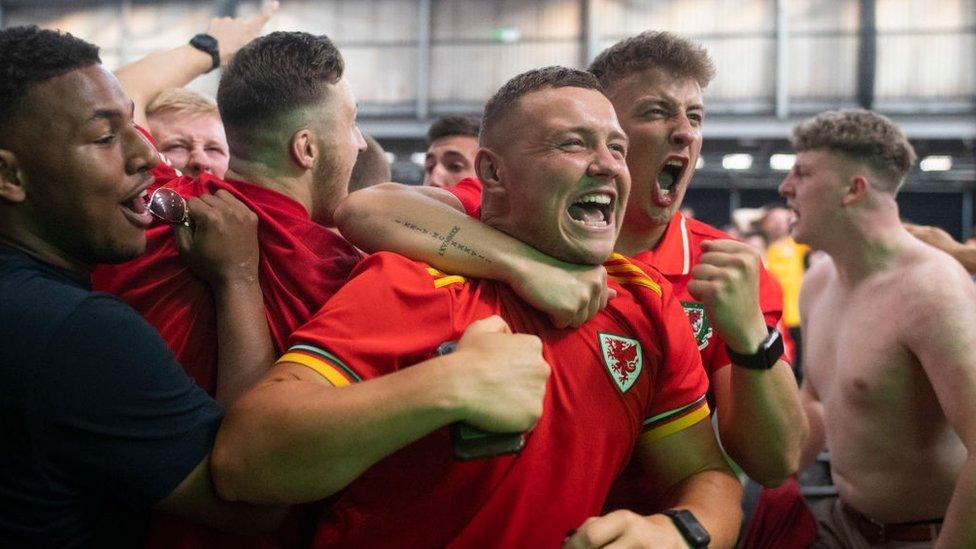 Football fans react as they watch Wales v Turkey at the Vale Sports Arena on June 16