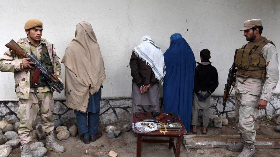 Afghan security forces show four suspected members of the Islamic State group captured in Nangarhar province where IS and Taliban fighters have battled each other