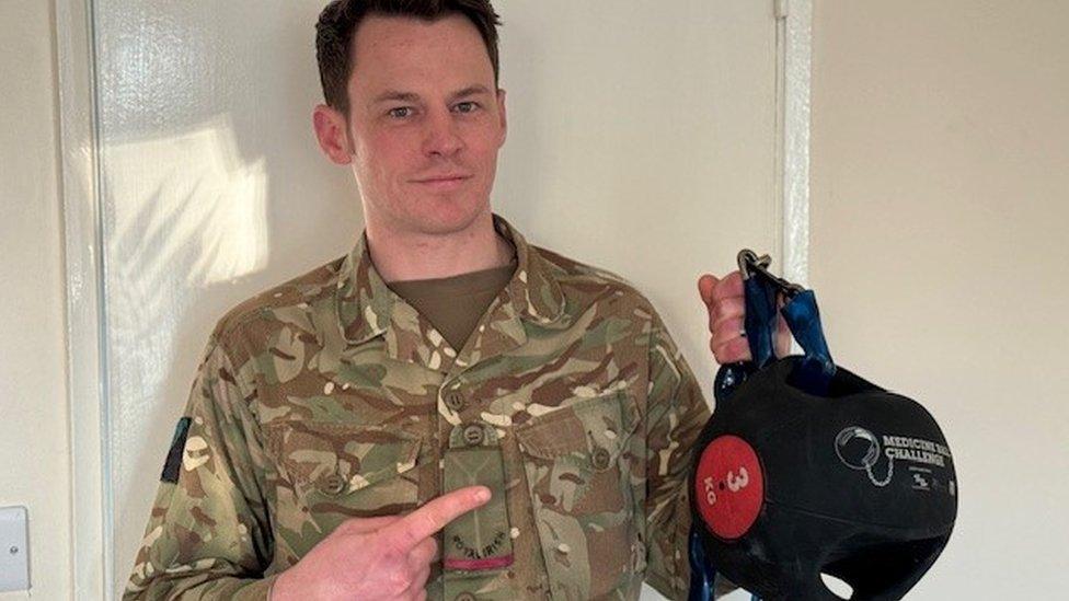 Johnny Bradley holding a medicine ball