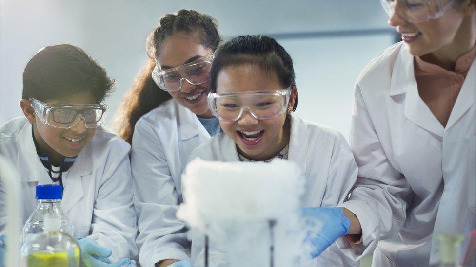 Secondary school children doing a science experiment