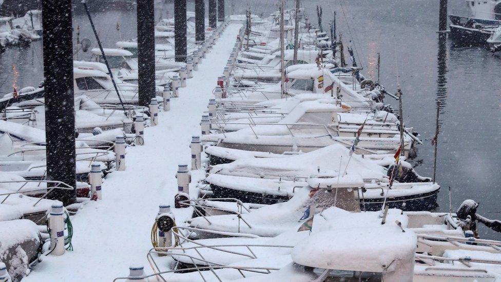 Snow covers boats moored at the port of San Sebastian after a snowstorm hit Basque Country, northern Spain