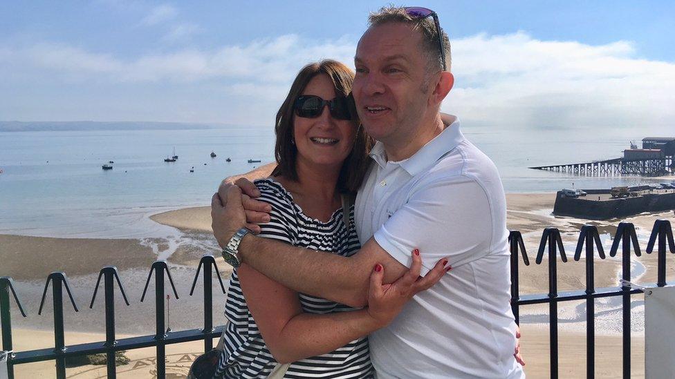 Emma Cornick and Neil Brierley hugging at Tenby beach after getting engaged