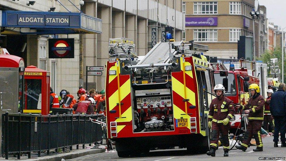 Police and fire personnel work outside London's Aldgate Station after an explosion occurred on the Circle line 07 July, 2005.