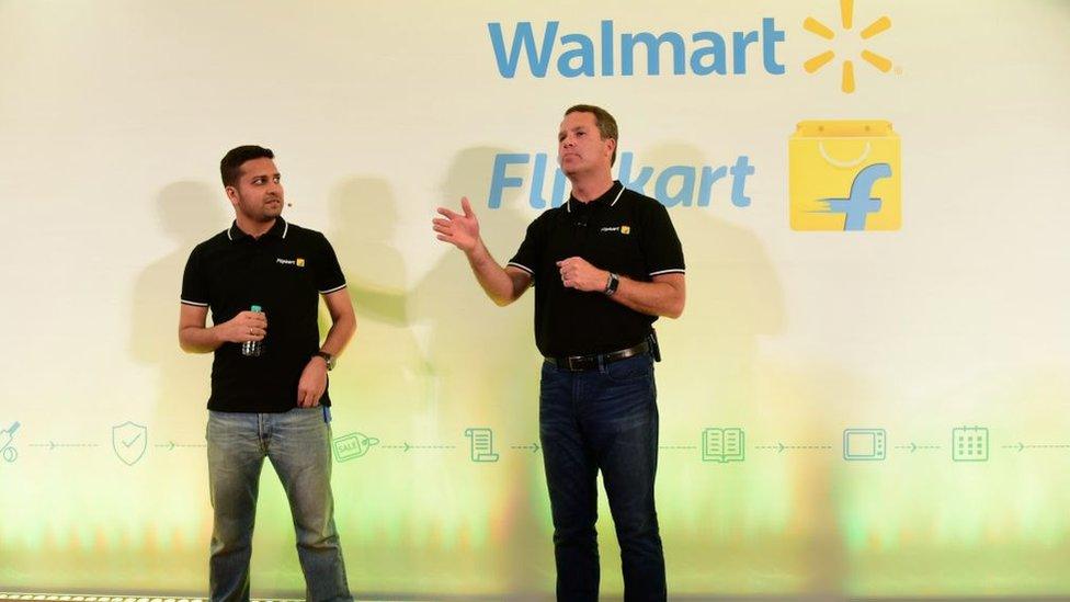 Walmart CEO Doug McMillon (R) speaking next to Flipkart co-founder and CEO Binny Bansal at an event in Bangalore