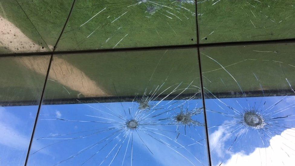 Windows shattered by flint stones