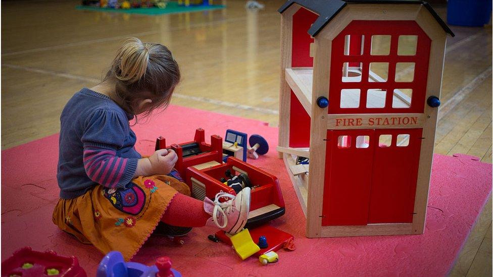 A child playing in a nursery school in England