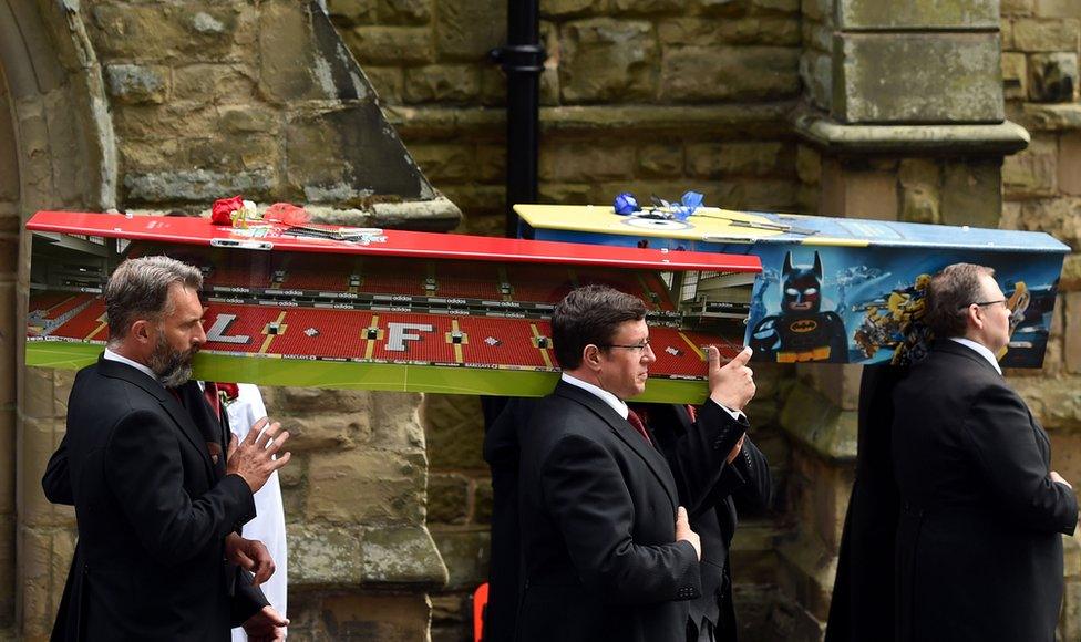 The coffins of Matthew and Adam Stokes leaving St Mary's Church, Hinckley, Leicestershire, after their funeral service