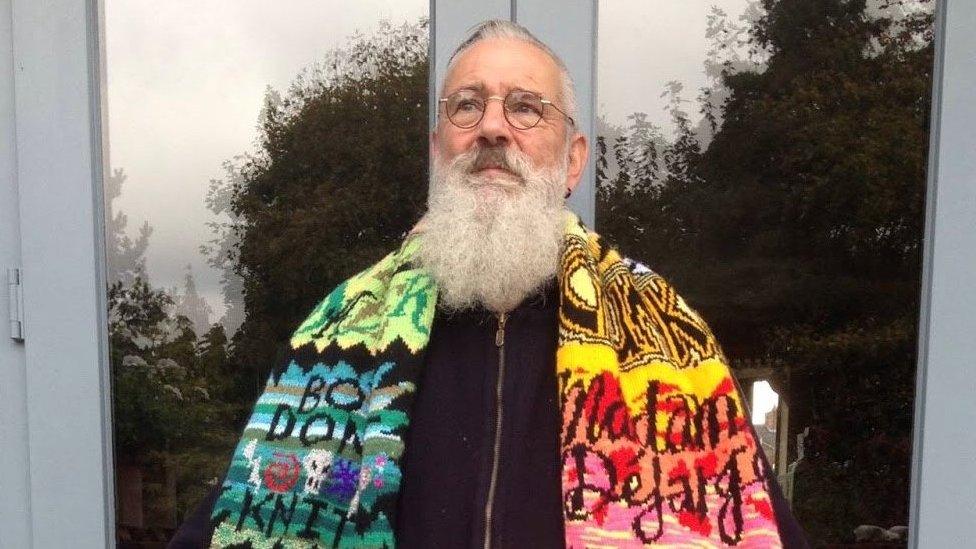 David Shenton wearing a hand-knitted scarf