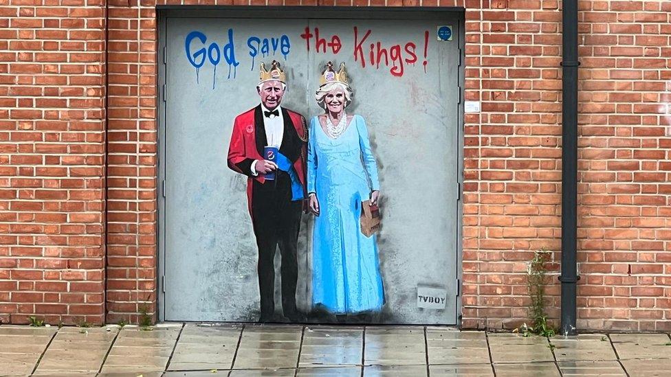 Graffiti portrait of King Charles and Queen Camilla