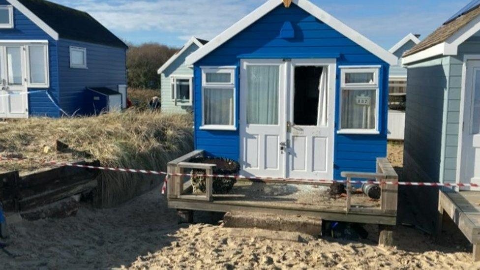 Damaged beach hut