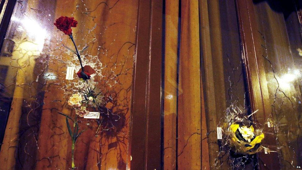 Flowers in window shattered by bullets