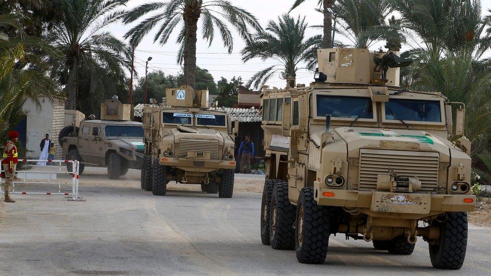 Security forces patrol near the al-Rawda mosque in the northern city of El-Arish, Sinai, Egypt (23 November 2018)