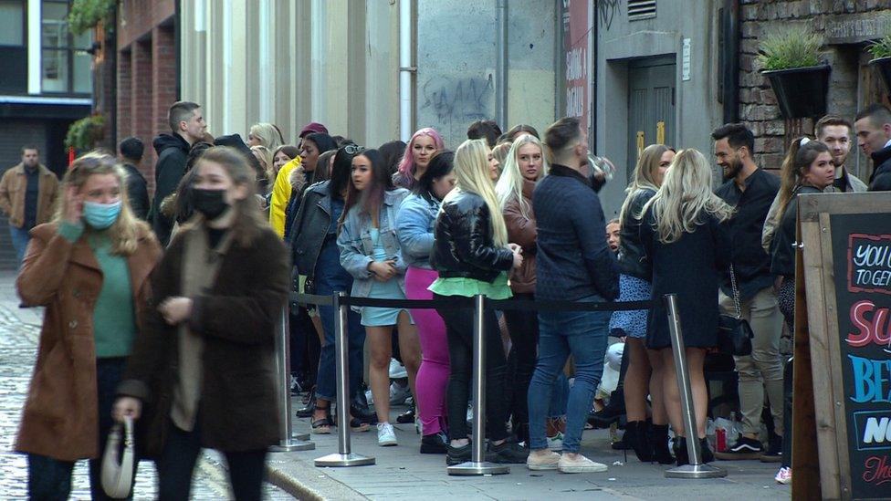 A queue of people outside a bar in Belfast