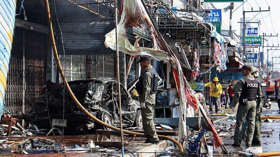 Thai bomb squad officers inspect the site of a bomb blast in Thailand's restive southern province of Yala