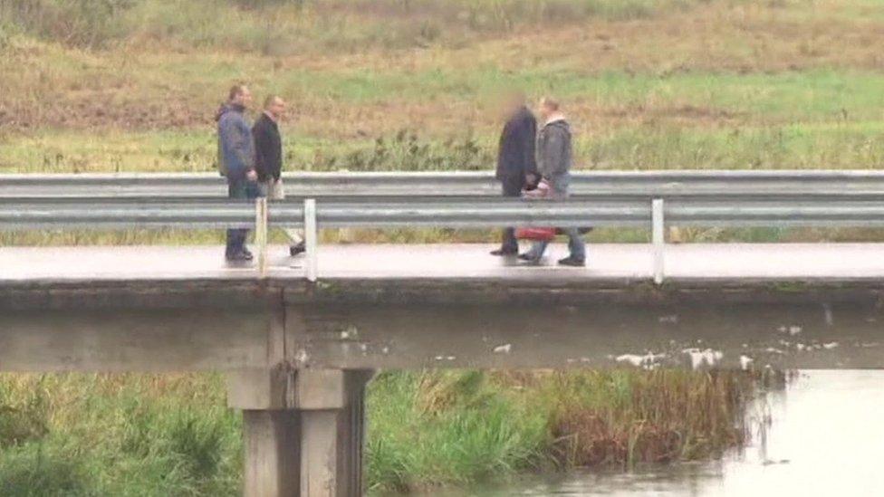 The swap taking place on a bridge separating the two countries