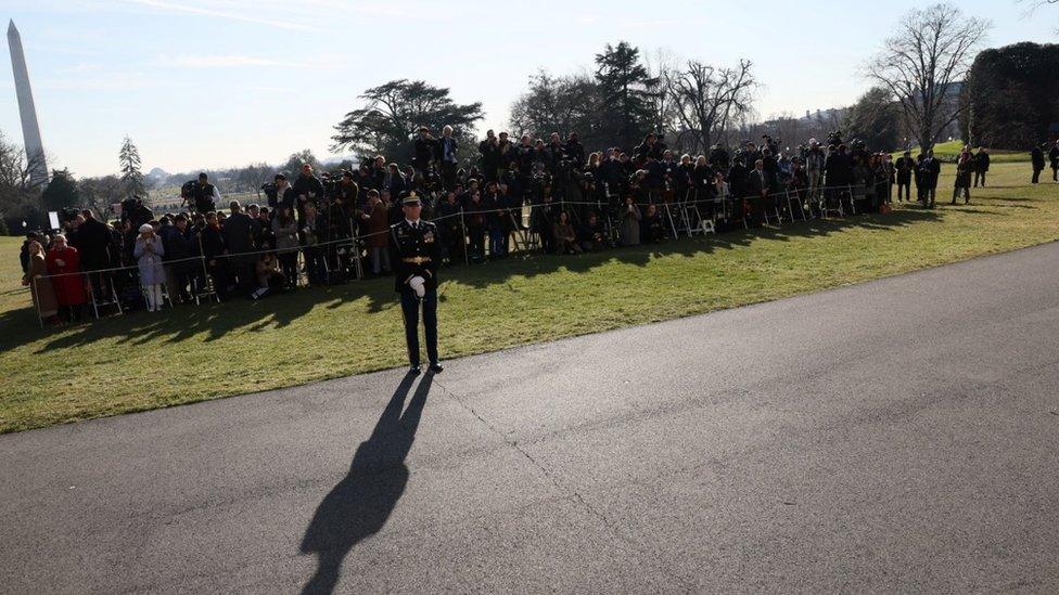 People wait for the arrival of Ukraine's President Volodymyr Zelensky at the White House