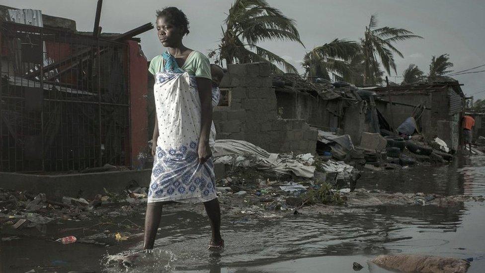 a local resident walking among the ruins after cyclone Idai