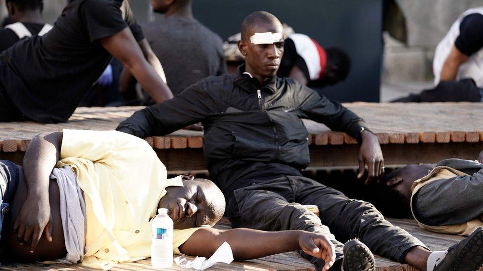 Protesters, injured during the evacuation of the Panthéon by police, wait prior to receiving medical assistance