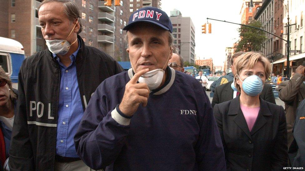 New York Governor George Pataki (L), New York City Mayor Rudolph Giuliani (C) and US Senator Hillary Rodham Clinton (R), D-NY, tour the site of the World Trade Center disaster 12 September 2001 in New York.