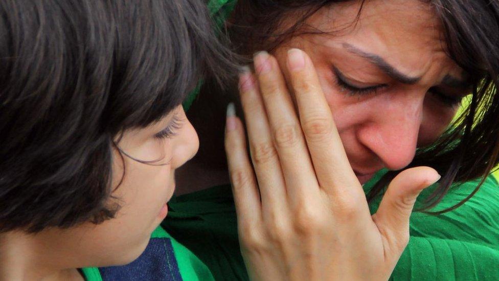 A child and woman, refugess heading for Christmas Island, Australia