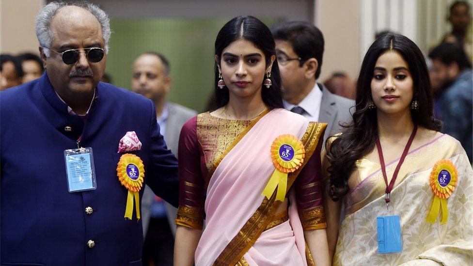 Husband of late Bollywood actress Sridevi Kapoor, Boney Kapoor (L), and her daughters Janhvi (R) and Khushi Kapoor look on during the 65th National Film Awards ceremony in New Delhi on May 3, 2018