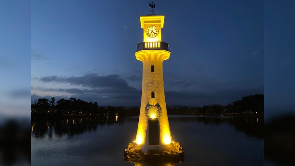 Roath Park clock tower lit up in yellow