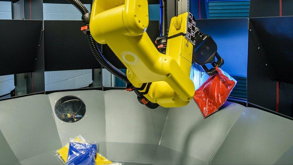 A Kindred system robot sorting clothes