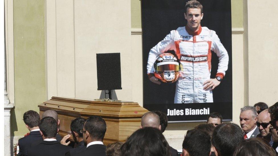 Pallbearers carry the casket of French Formula 1 driver Jules Bianchi into Sainte Reparate Cathedral during his funeral in Nice, French Riviera, Tuesday, July 21, 2015