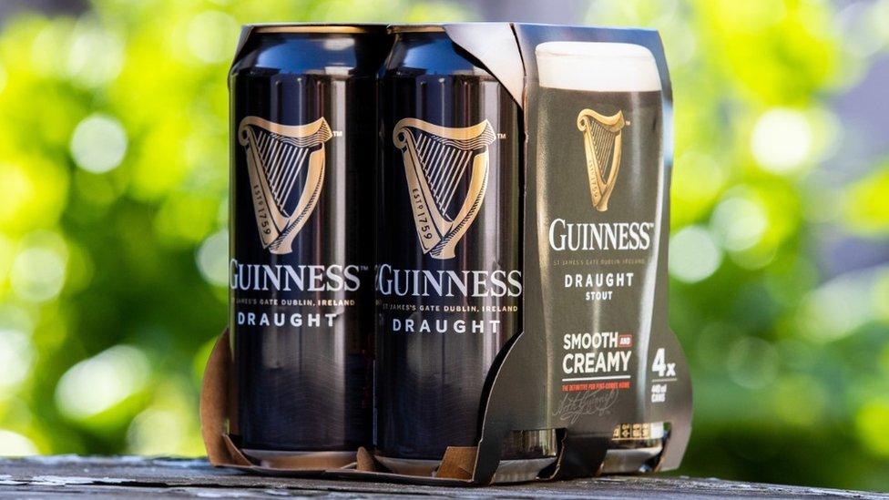 Guinness cans in cardboard box