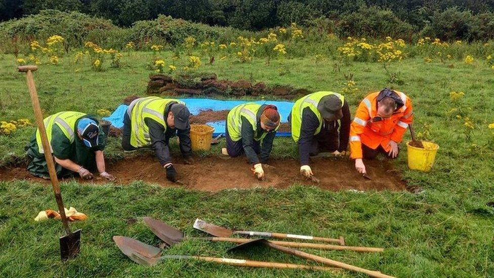 Volunteers excavating site