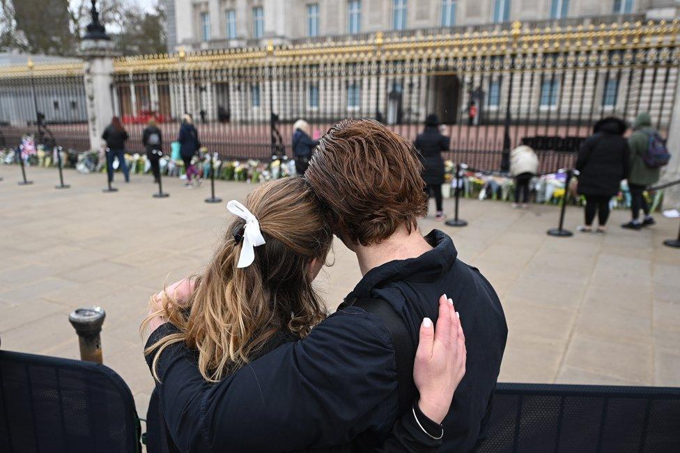 people gather outside Buckingham Palace a day after the passing of Britain's Prince Philip in London. 10 April 2021.